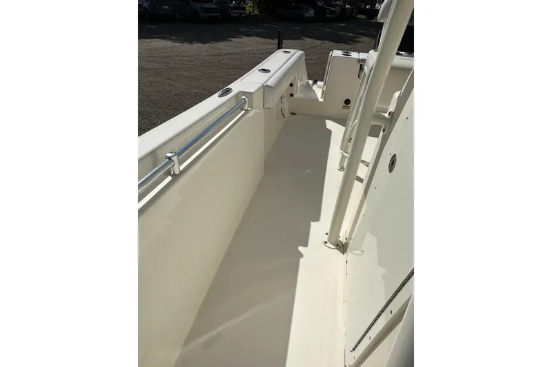 Slide: The Image of 2022 Cobia 220 Center Console boat interior with sleek white deck and railing. - 27