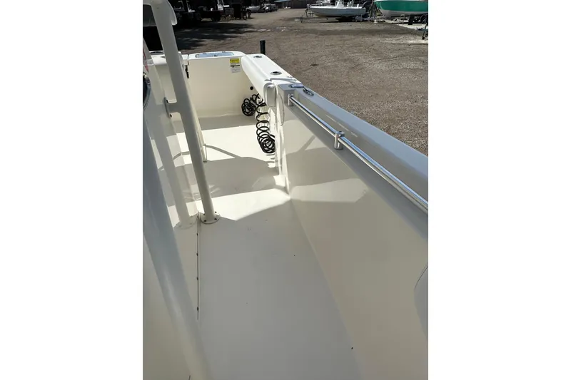 Slide: The Image of 2022 Cobia 220 Center Console boat interior with clean deck and railing. - 28