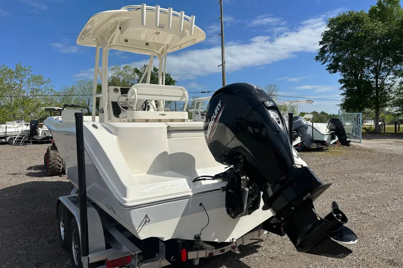 Slide: The Image of 2022 Cobia 220 Center Console boat with Mercury outboard engine on trailer. - 3
