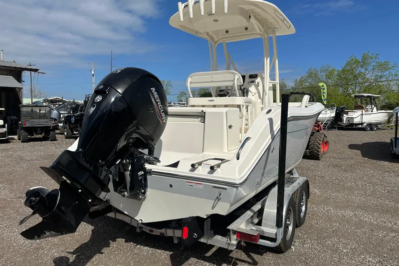 Slide: The Image of 2022 Cobia 220 Center Console boat with Mercury engine on trailer. - 4