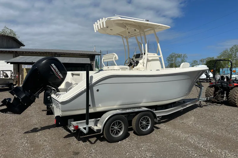 Slide: The Image of 2022 Cobia 220 Center Console boat on trailer with Mercury outboard motor. - 5