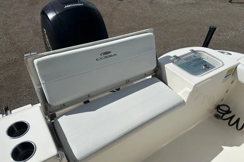 Slide: The Image of 2022 Cobia 220 Center Console boat with seating and Mercury engine. - 8