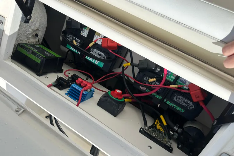 Slide: The Image of Battery compartment of 2022 Cobia 220 Center Console boat with wiring and components. - 9
