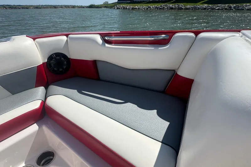 Slide: The Image of 2017 Moomba Helix boat interior with red and gray seating by the water. - 11