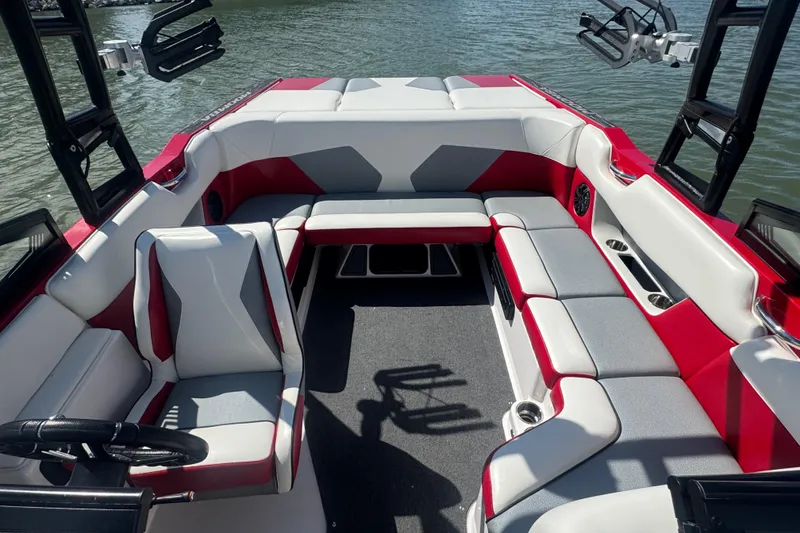 Slide: The Image of 2017 Moomba Helix boat interior with red and gray seating on the water. - 12