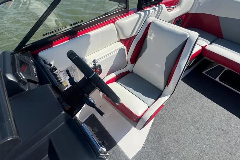 Slide: The Image of 2017 Moomba Helix boat interior with steering wheel and seating. - 13