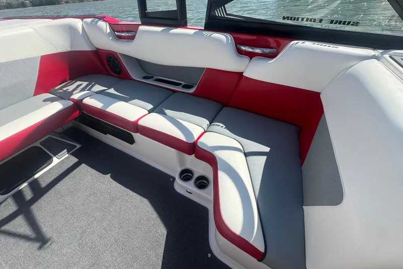 Slide: The Image of 2017 Moomba Helix boat interior with red and white seating, on a sunny day. - 20