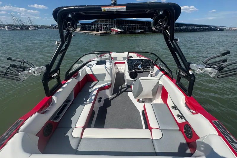 Slide: The Image of 2017 Moomba Helix boat interior with red and white seating, on a sunny lake. - 24