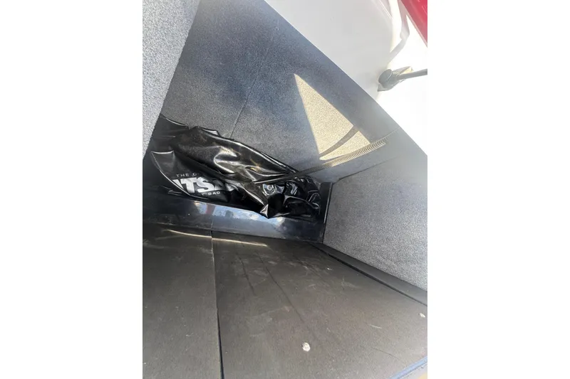 Slide: The Image of 2017 Moomba Helix storage compartment with ballast bag, featuring carpeted interior. - 29