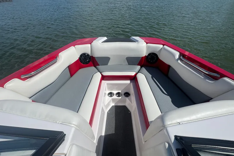 Slide: The Image of 2017 Moomba Helix boat interior with red and gray seating on water. - 9