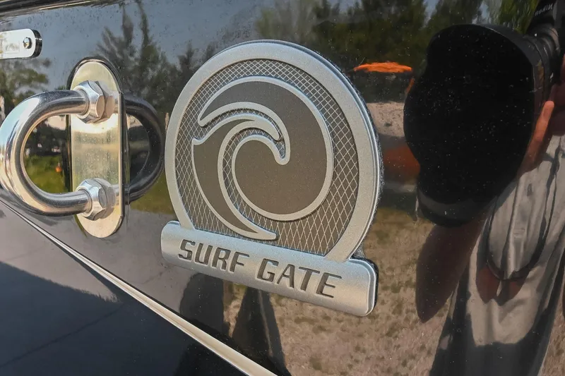 Slide: The Image of 2023 Axis T220 Surf Gate emblem on a sleek black surface. - 10