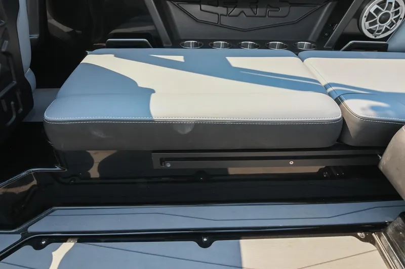 Slide: The Image of 2023 Axis T220 boat interior seating with cup holders and speaker. - 22