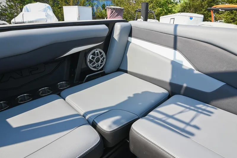 Slide: The Image of 2023 Axis T220 boat interior with gray seating and speaker system. - 23