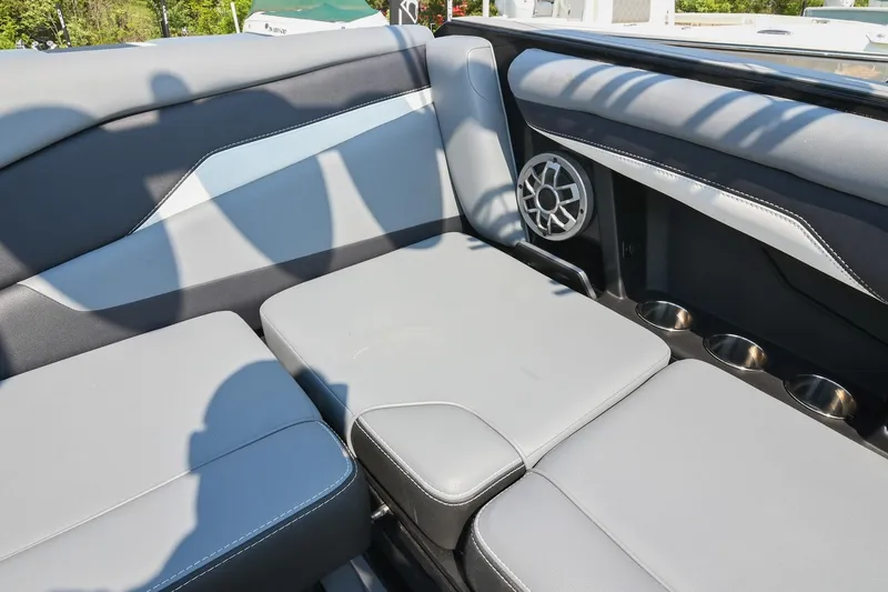 Slide: The Image of 2023 Axis T220 boat interior with gray seating, speaker, and cup holders. - 25