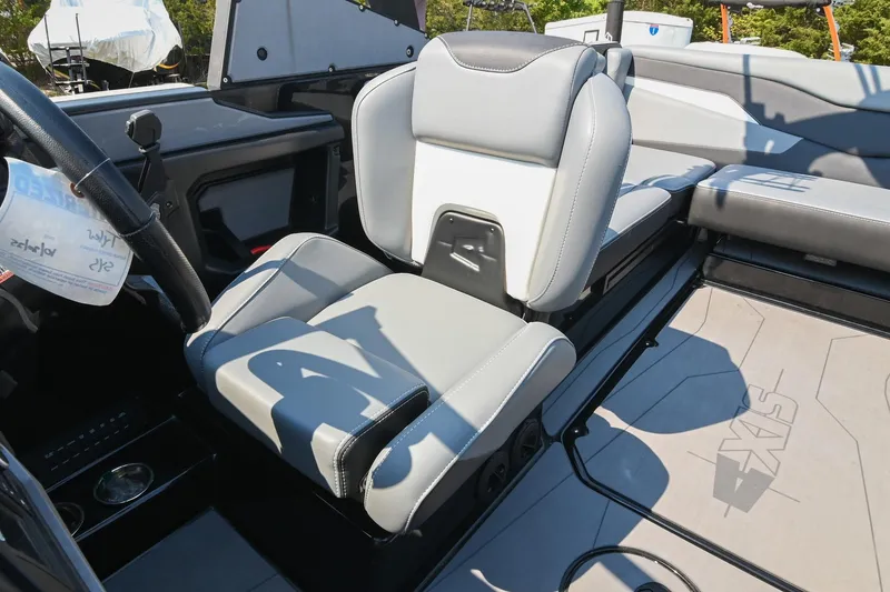 Slide: The Image of 2023 Axis T220 boat interior with gray seating and steering wheel. - 35