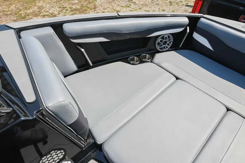 Slide: The Image of 2023 Axis T220 boat interior with gray seating, cup holders, and speaker system. - 38