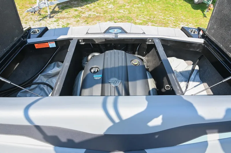 Slide: The Image of 2023 Axis T220 boat engine compartment with open hatch, showcasing engine details. - 46