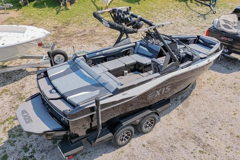 Slide: The Image of 2023 Axis T220 boat on trailer, sleek design, black exterior, spacious interior. - 54
