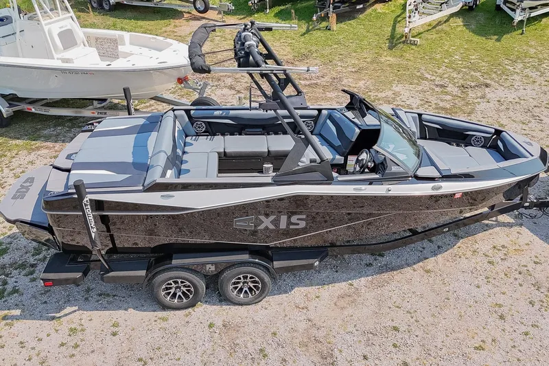 Slide: The Image of 2023 Axis T220 boat on trailer, sleek design, parked outdoors. - 55