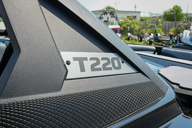 Slide: The Image of 2023 Axis T220 boat detail with textured design and logo in outdoor setting. - 7