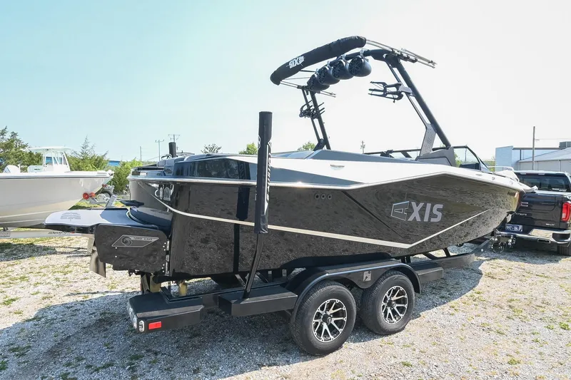 Slide: The Image of 2023 Axis T220 boat on trailer, black exterior, parked outdoors. - 8