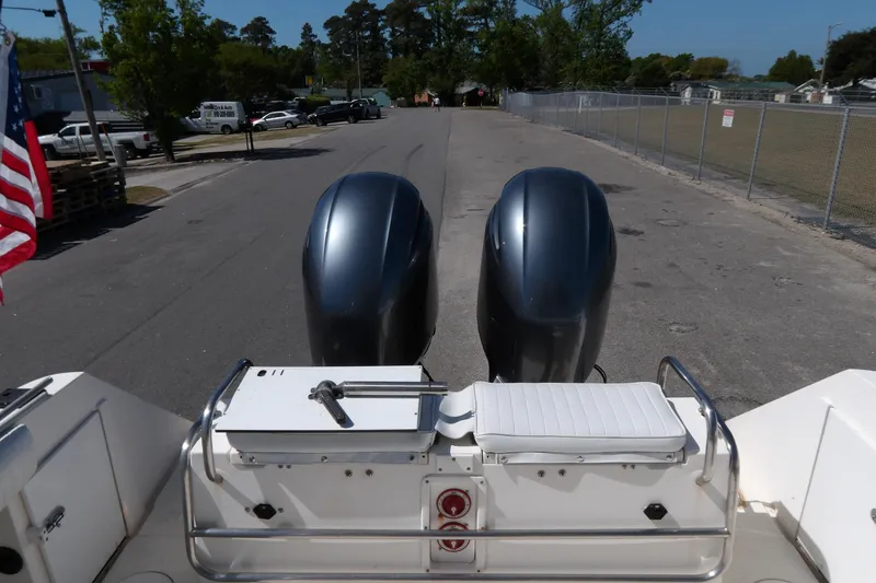 Slide: The Image of 1993 Wahoo 2600 boat with dual outboard motors on a street. - 16