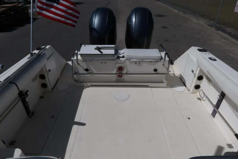 Slide: The Image of 1993 Wahoo 2600 boat deck with dual engines and American flag. - 17
