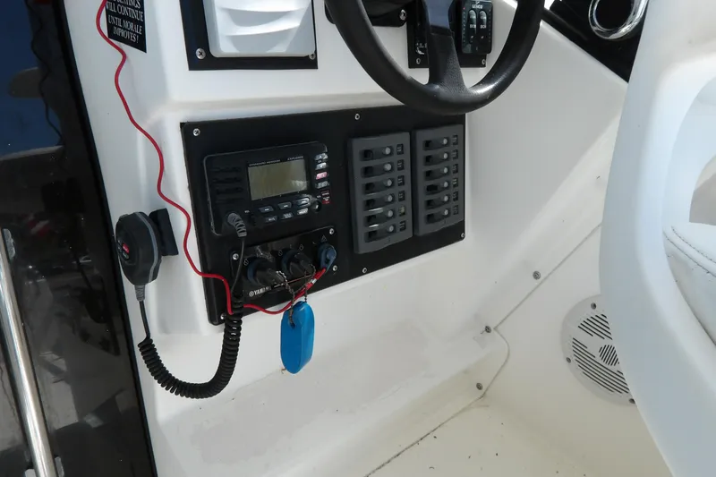 Slide: The Image of Control panel of a 1993 Wahoo 2600 boat with steering wheel and radio equipment. - 33