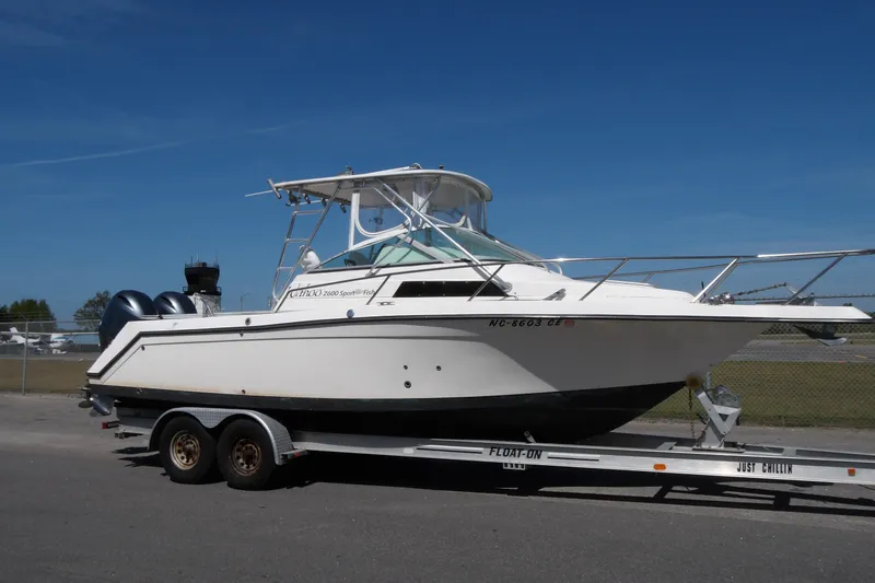 The Image of 1993 Wahoo 2600 boat on trailer under clear blue sky. - 1