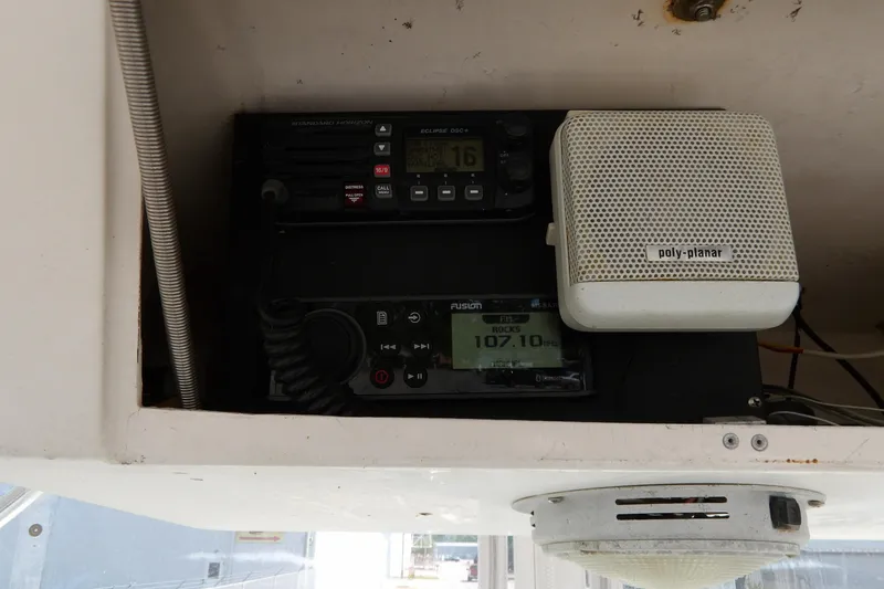 Slide: The Image of 1993 Wahoo 2600 boat electronics, featuring radio and speaker system in cabin. - 15