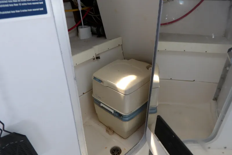 Slide: The Image of Portable toilet inside a 1993 Wahoo 2600 boat cabin. - 24