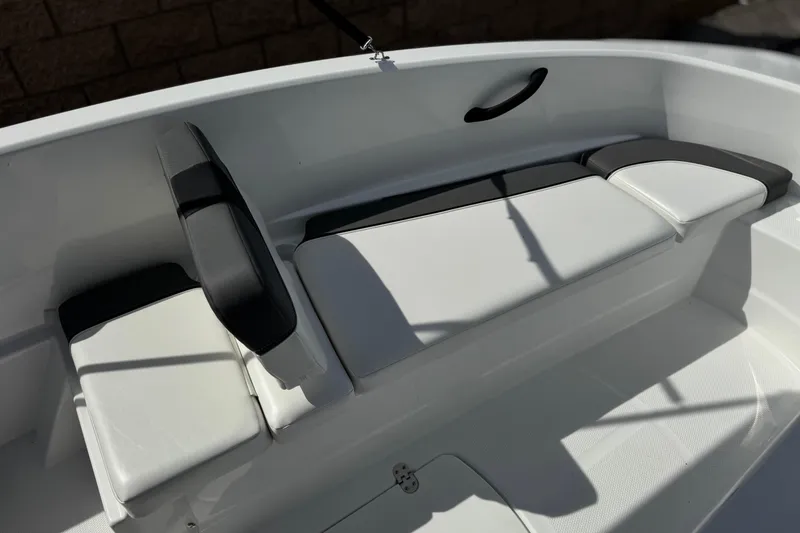 Slide: The Image of 2025 Tahoe T16 boat interior with white and black seating. - 12