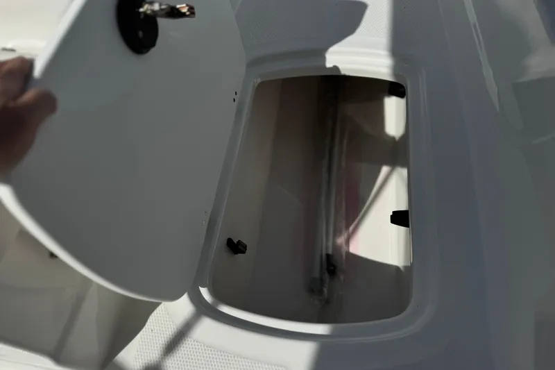 Slide: The Image of Open storage compartment on a 2025 Tahoe T16 boat, showing interior space. - 16