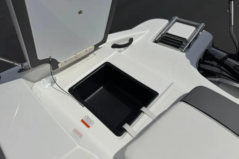 Slide: The Image of 2025 Tahoe T16 boat storage compartment with open lid and integrated ladder. - 22