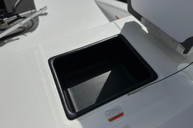 Slide: The Image of 2025 Tahoe T16 boat storage compartment with open lid, showcasing sleek design and functionality. - 23