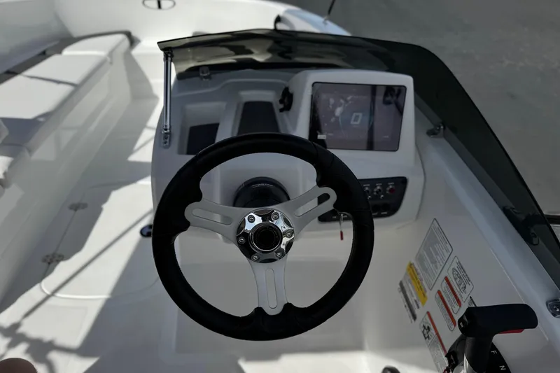 Slide: The Image of Steering console of 2025 Tahoe T16 boat with modern controls and display. - 25