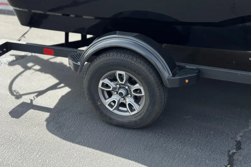 Slide: The Image of 2025 Tahoe T16 trailer wheel and fender on asphalt surface. - 32