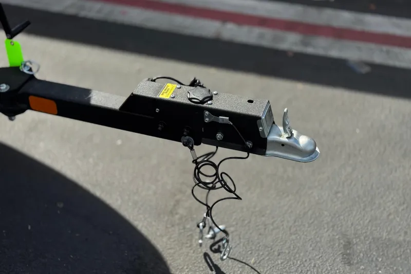 Slide: The Image of Trailer hitch of a 2025 Tahoe T16 on asphalt background. - 33