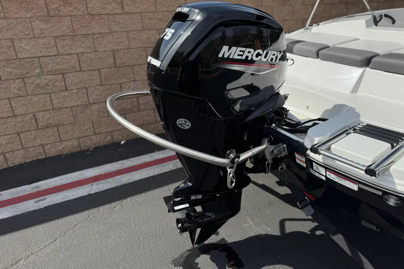 Slide: The Image of 2025 Tahoe T16 boat with Mercury outboard motor, parked on concrete near brick wall. - 6