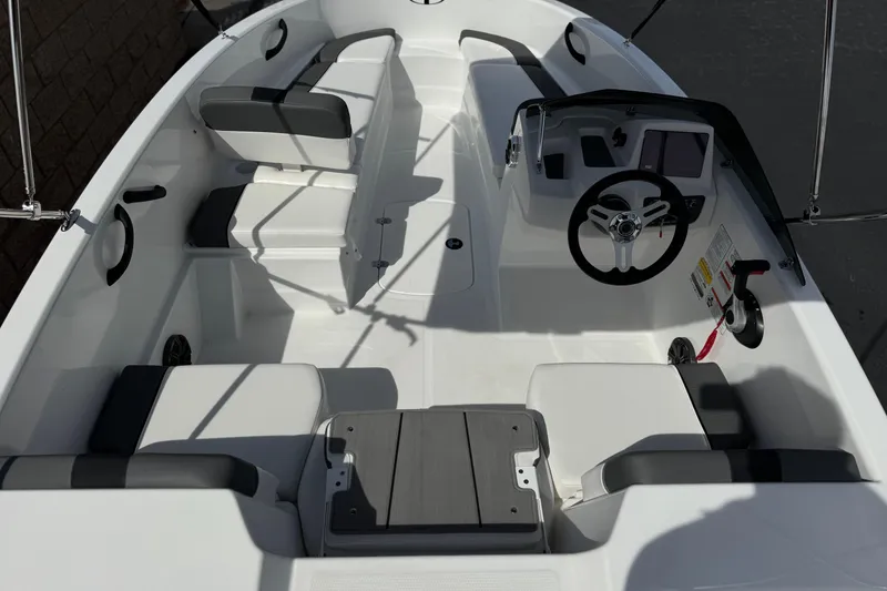Slide: The Image of 2025 Tahoe T16 boat interior with steering wheel and seating arrangement. - 9