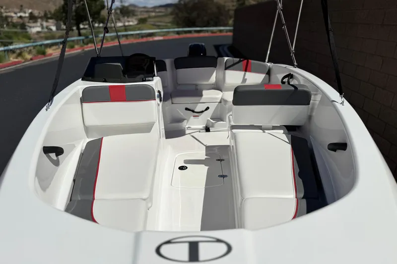 Slide: The Image of 2024 Tahoe T16 boat interior with white and red seating, sleek design. - 10