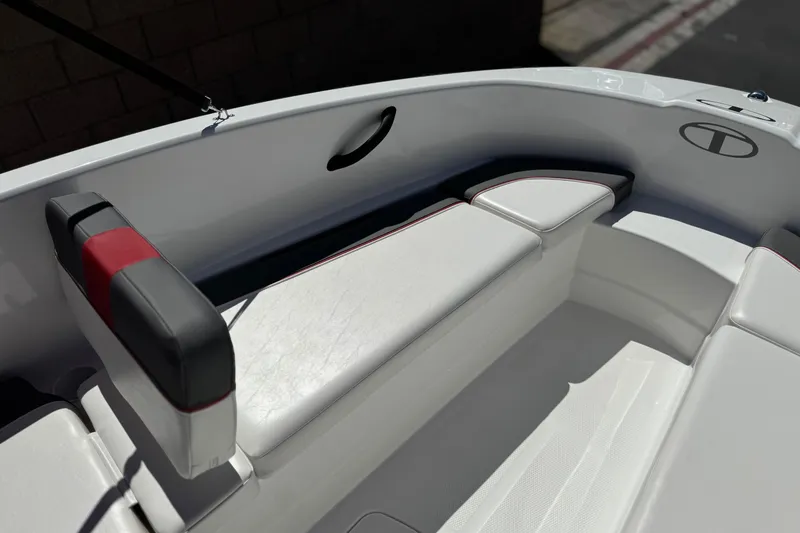 Slide: The Image of 2024 Tahoe T16 boat interior with white and black seating, featuring red accents. - 12