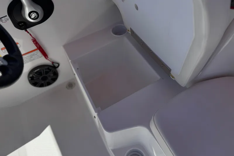 Slide: The Image of 2024 Tahoe T16 boat interior with storage compartment and steering wheel. - 21