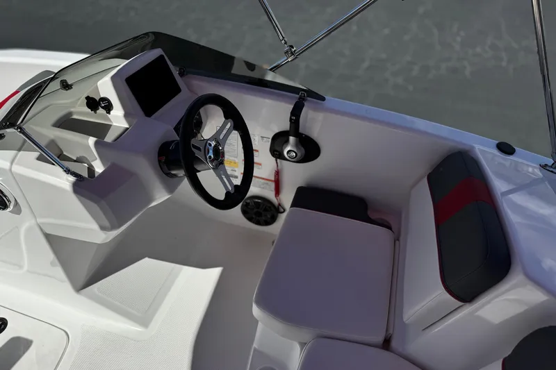 Slide: The Image of 2024 Tahoe T16 boat interior with steering wheel and seating, showcasing modern design. - 23