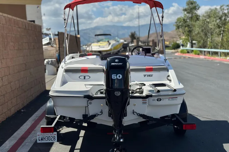 Slide: The Image of 2024 Tahoe T16 boat with Mercury 60 engine, parked outdoors. - 4