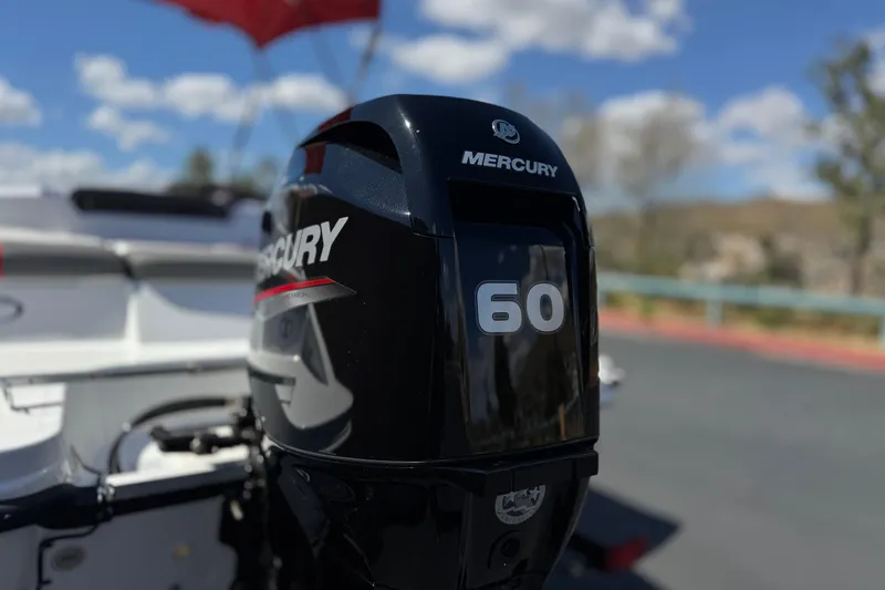 Slide: The Image of Mercury 60 horsepower engine on 2024 Tahoe T16 boat, outdoors under blue sky. - 8