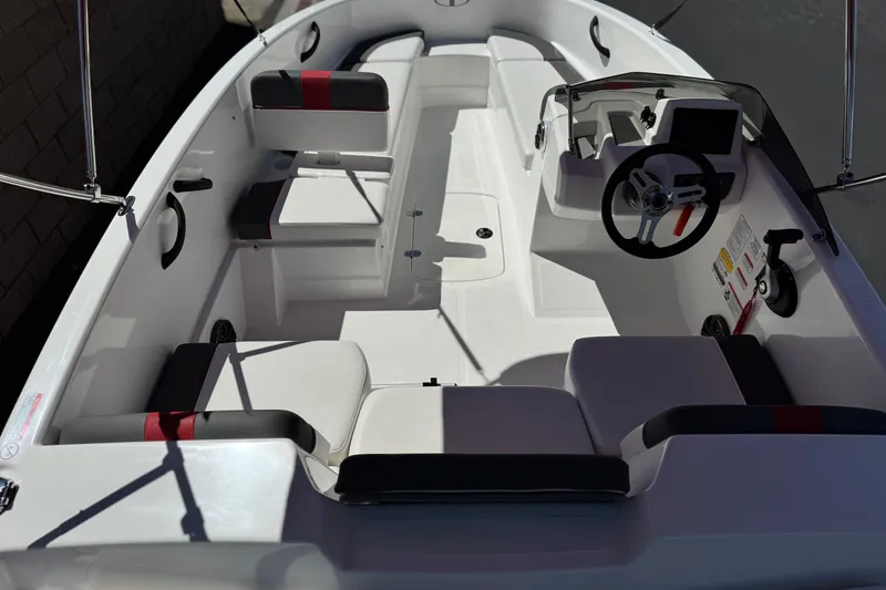 Slide: The Image of 2024 Tahoe T16 boat interior with modern seating and steering console. - 9