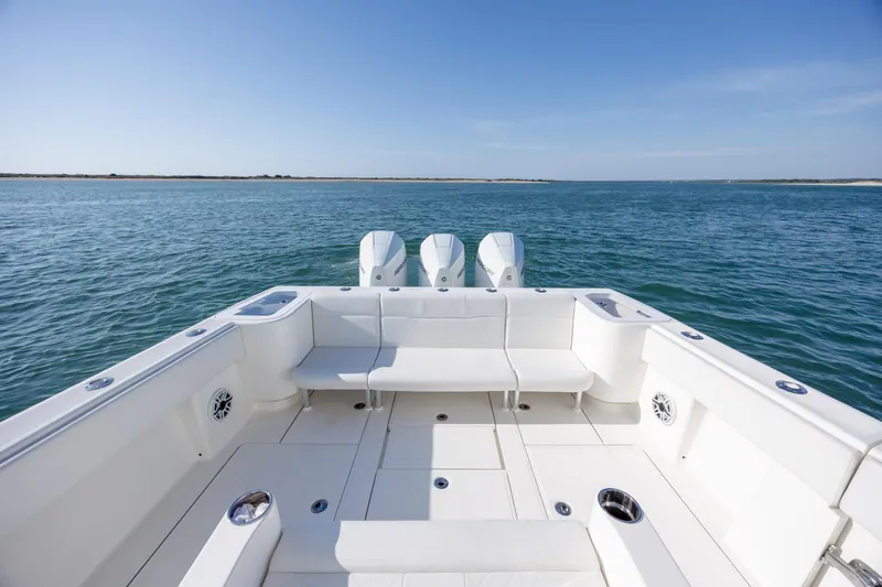 Slide: The Image of 2019 SeaVee 370Z boat with triple engines on open water, featuring spacious seating. - 10