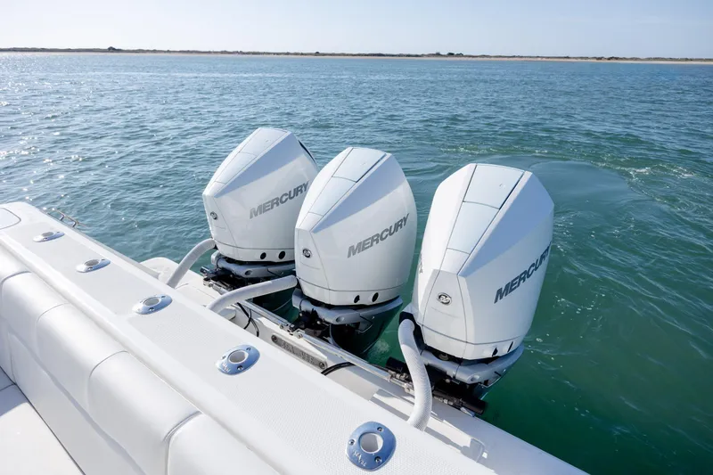 Slide: The Image of 2019 SeaVee 370Z boat with triple Mercury outboard engines on open water. - 11