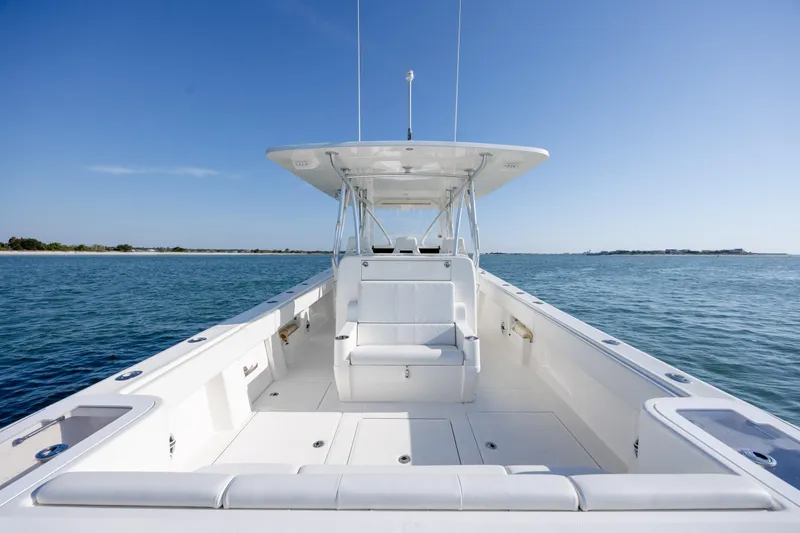 Slide: The Image of 2019 SeaVee 370Z boat on calm water, featuring spacious deck and seating. - 14